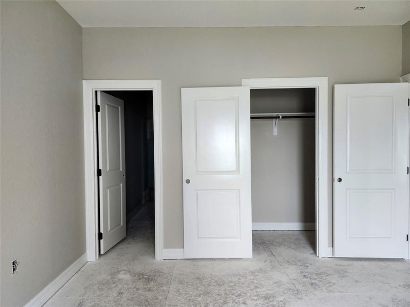 This photo shows a bedroom with light gray walls.