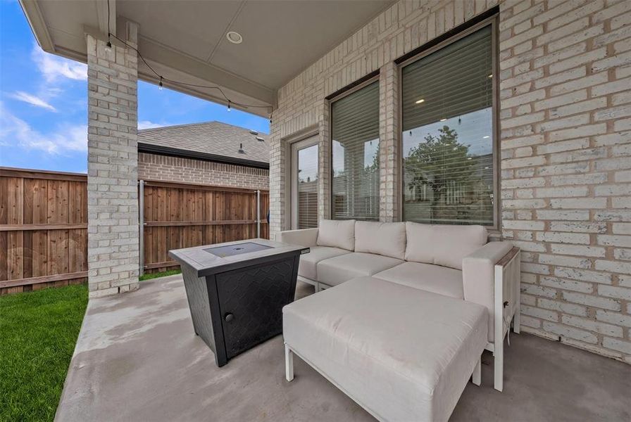 Covered patio featuring a concrete slab and string lighting Covered patio featuring a concrete slab and string lighting