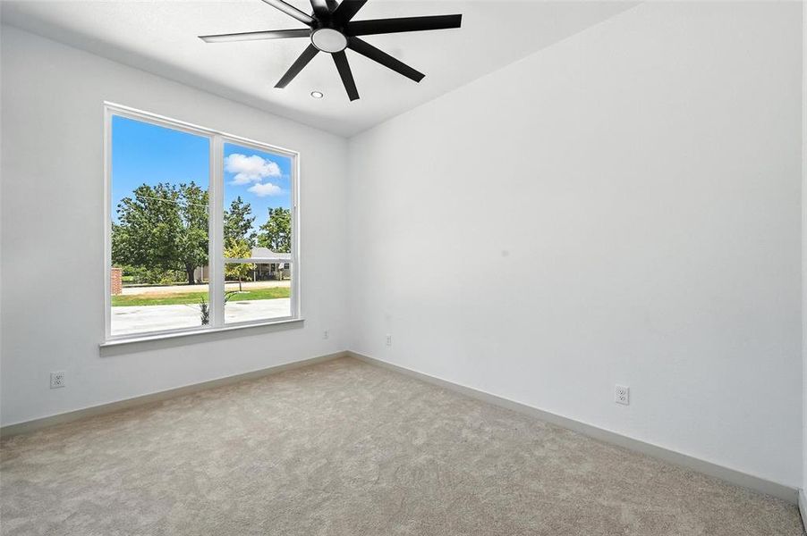 Empty room with light colored carpet, a ceiling fan, and recessed lighting Empty room with light colored carpet, a ceiling fan, and recessed lighting
