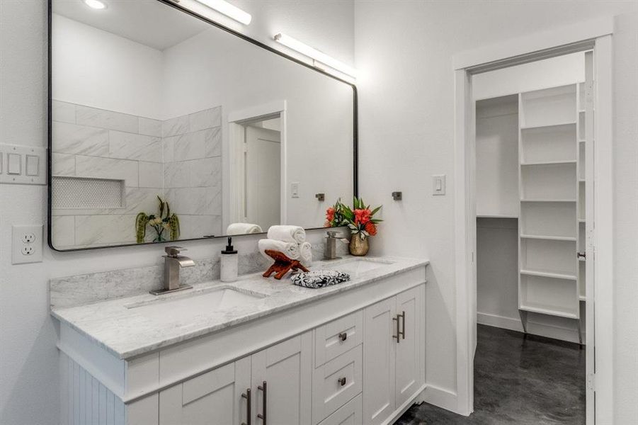 Bathroom with vanity and concrete flooring