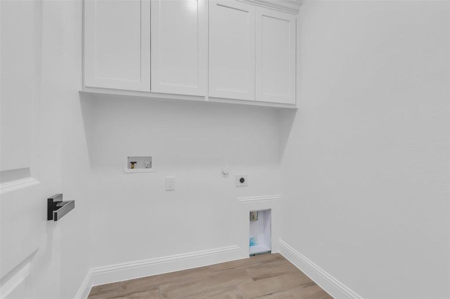 Laundry room with lots of storage space and washer/dryer hookup.