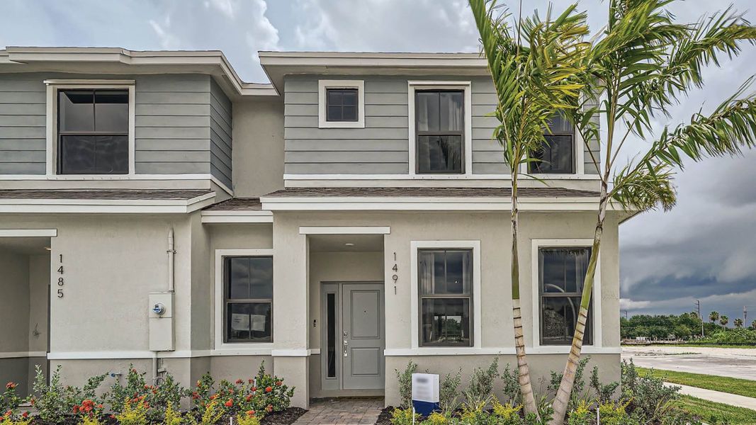 Front exterior of a new home in Palm Cay, Florida City, FL, highlighting curb appeal (Image 1). Front exterior of a new home in Palm Cay, Florida City, FL, highlighting curb appeal (Image 1).