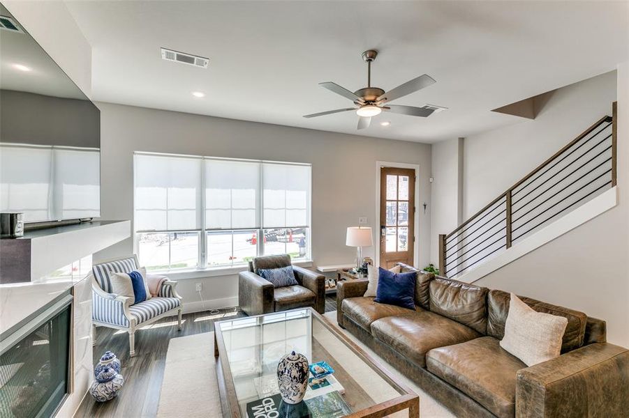 Living room featuring wine cooler, ceiling fan, plenty of natural light, and hardwood / wood-style flooring