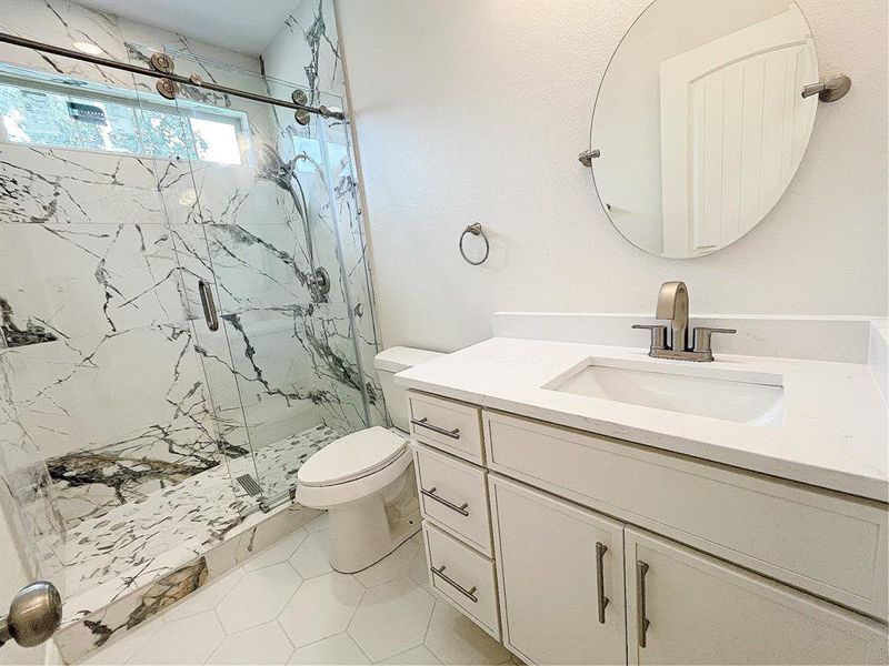 ondary full-bath with beautiful granite shower & large hexagon tiles