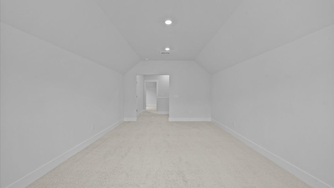 Inviting bonus room with cozy carpet, perfect for casual gatherings or quiet relaxation Inviting bonus room with cozy carpet, perfect for casual gatherings or quiet relaxation