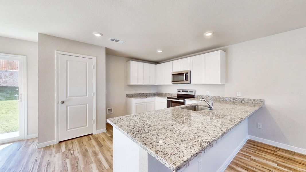 A kitchen with marble counters.