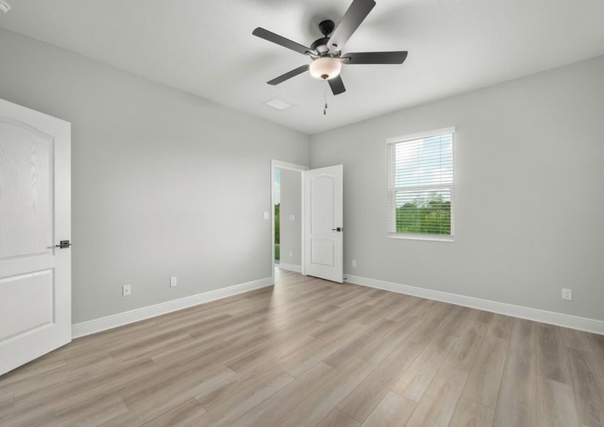 Master bedroom with a window facing the backyard Master bedroom with a window facing the backyard