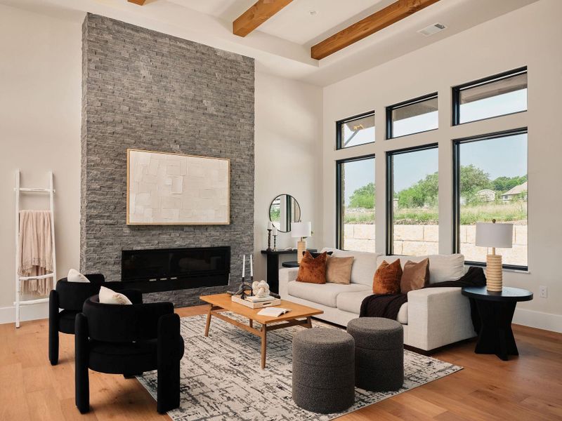 An inviting gathering space features a towering stone fireplace and large windows that illuminate the room. An inviting gathering space features a towering stone fireplace and large windows that illuminate the room.