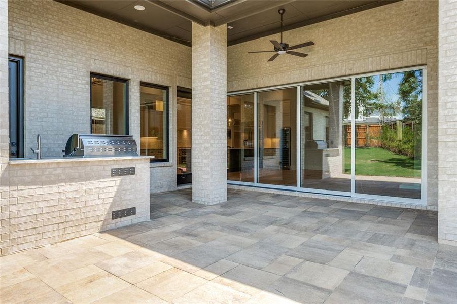 View of patio / terrace with exterior kitchen and a ceiling fan View of patio / terrace with exterior kitchen and a ceiling fan