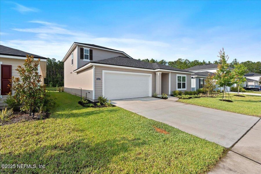 Front exterior of a new home in Dunns Crossing, Jacksonville, FL, highlighting curb appeal (Image 2). Front exterior of a new home in Dunns Crossing, Jacksonville, FL, highlighting curb appeal (Image 2).