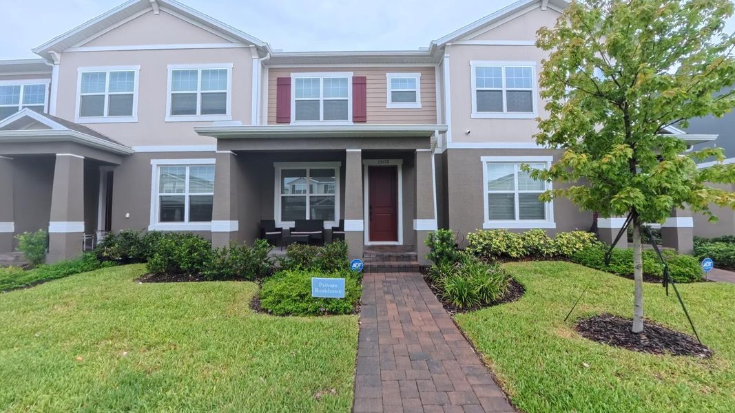 Front exterior of a new home in , Winter Garden, FL, highlighting curb appeal (Image 1).