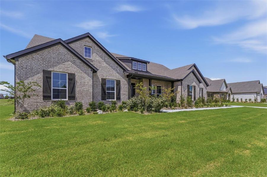Stone veneer and brick exterior with contrasting dark trim Stone veneer and brick exterior with contrasting dark trim