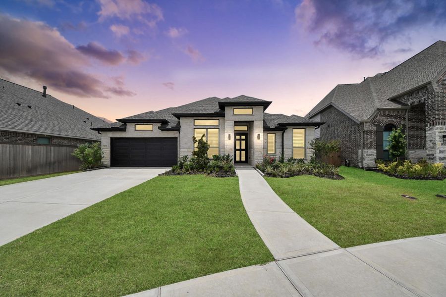Front exterior of a new home in Valencia, Manvel, TX, highlighting curb appeal (Image 27). Front exterior of a new home in Valencia, Manvel, TX, highlighting curb appeal (Image 27).