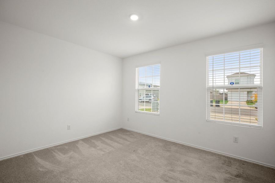 One of two well sized secondary bedrooms, this room overlooking the front yard.