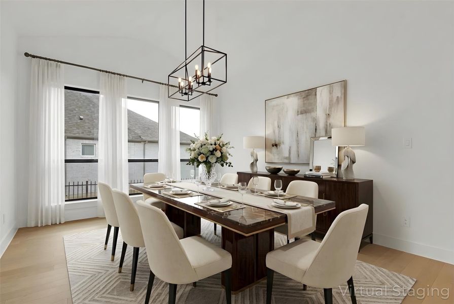 Virtually-Staged Formal Dining area with light hardwood floors, lofted ceiling, and a light chandelier