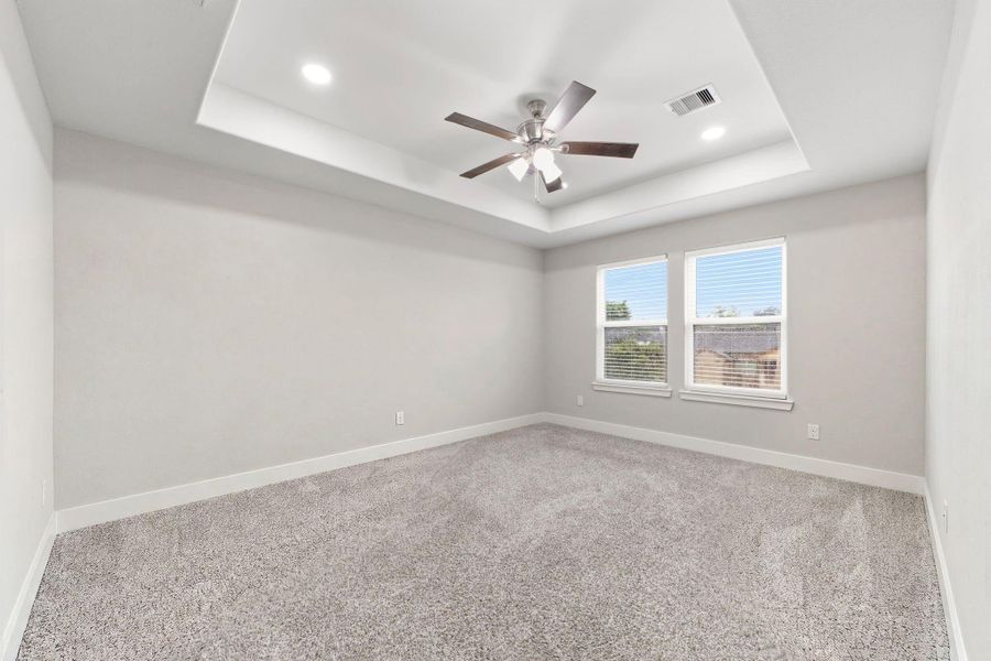 Light filled primary bedroom offers a peaceful retreat.