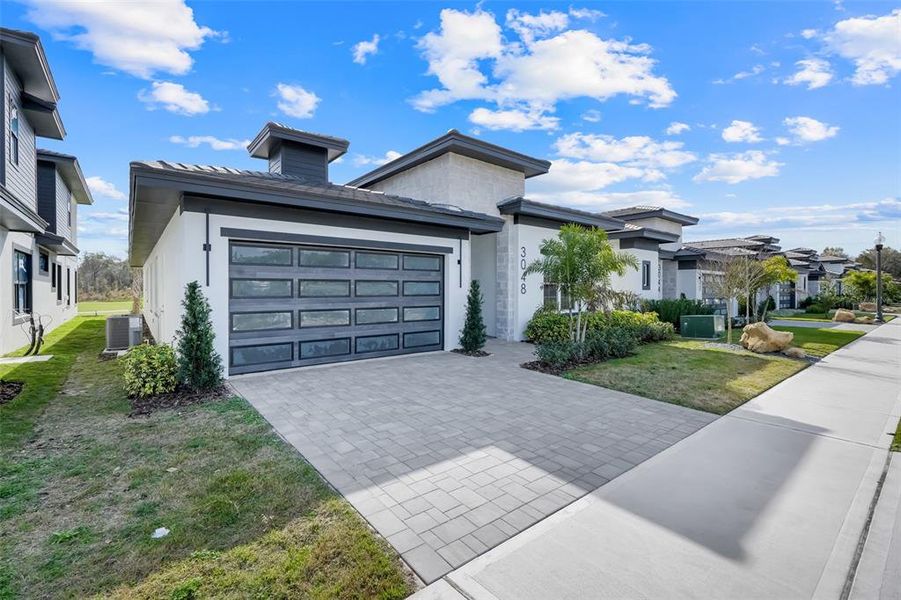 Front exterior of a new home in Hampton Green at Providence, Davenport, FL, highlighting curb appeal (Image 25).