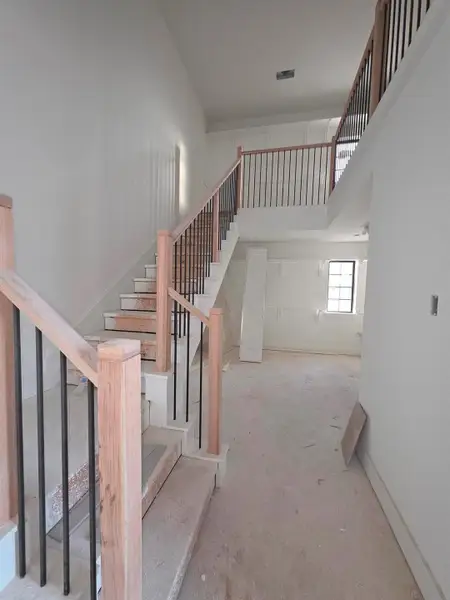 Luxurious two-story primary closet off the spa-like primary bath, featuring soaring ceilings, a boutique-style dressing area, and beautifully shelved on both levels. Luxurious two-story primary closet off the spa-like primary bath, featuring soaring ceilings, a boutique-style dressing area, and beautifully shelved on both levels.