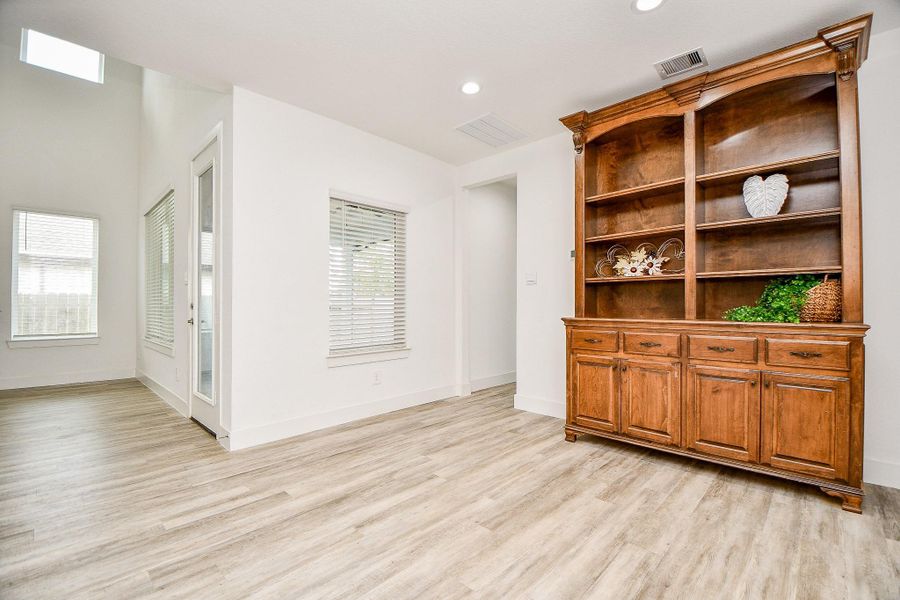 This bright, open breakfast area features large windows and a glass door let in natural light, enhancing the airy feel. This bright, open breakfast area features large windows and a glass door let in natural light, enhancing the airy feel.