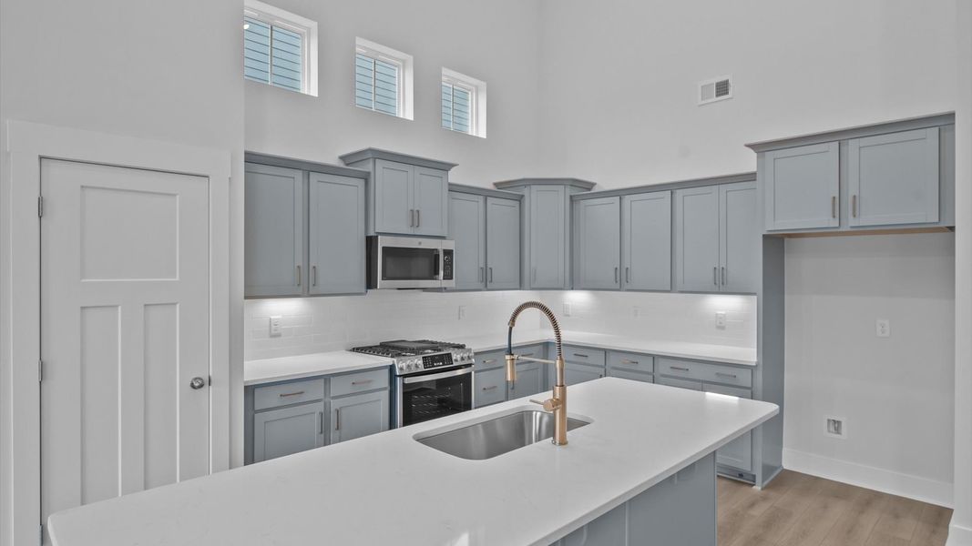 Highly skilled craftsmanship shines in this modern kitchen with a central island focal point Highly skilled craftsmanship shines in this modern kitchen with a central island focal point