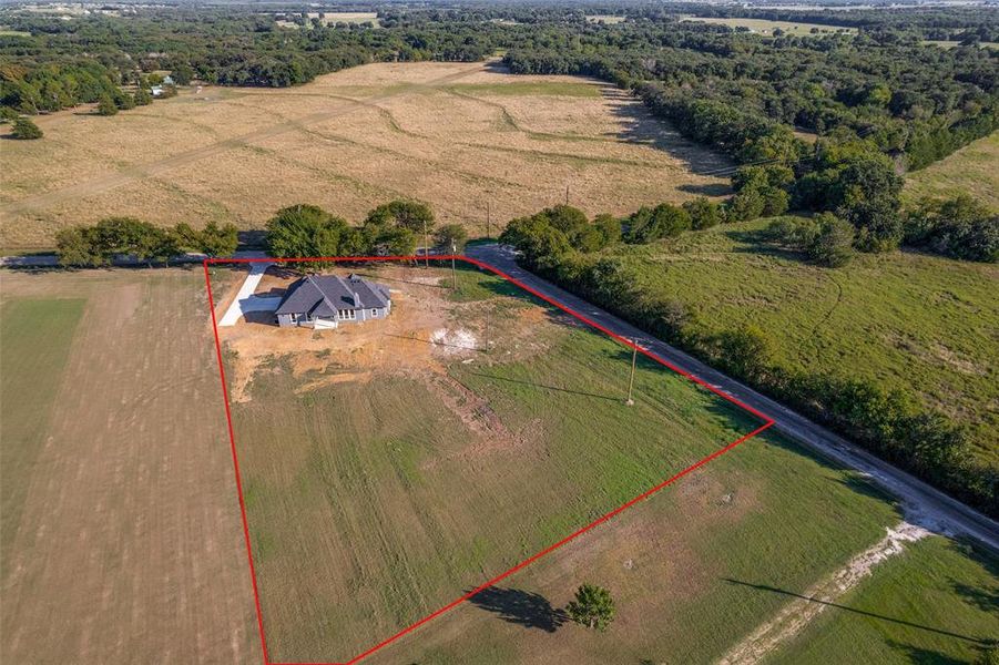 Aerial view of sparsely populated area featuring property boundaries highlighted Aerial view of sparsely populated area featuring property boundaries highlighted