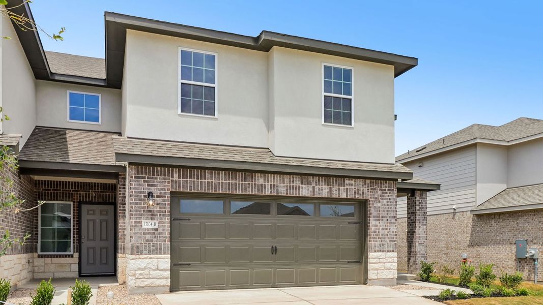Front exterior of a new home in Palomino, Manor, TX, highlighting curb appeal (Image 2).
