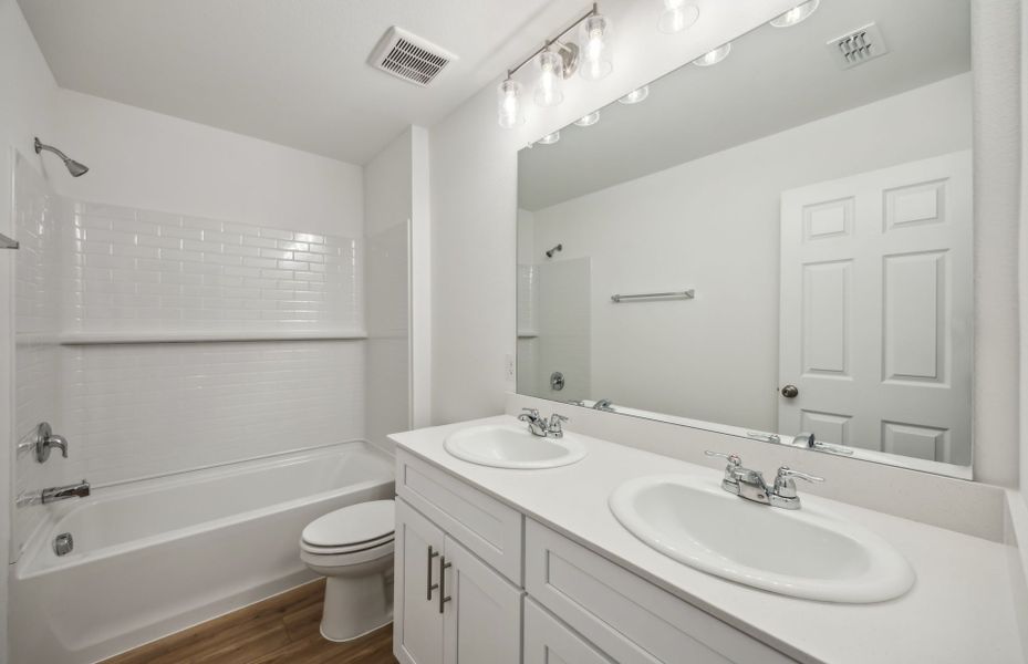 Spacious secondary bathroom with dual vanity *real home pictured