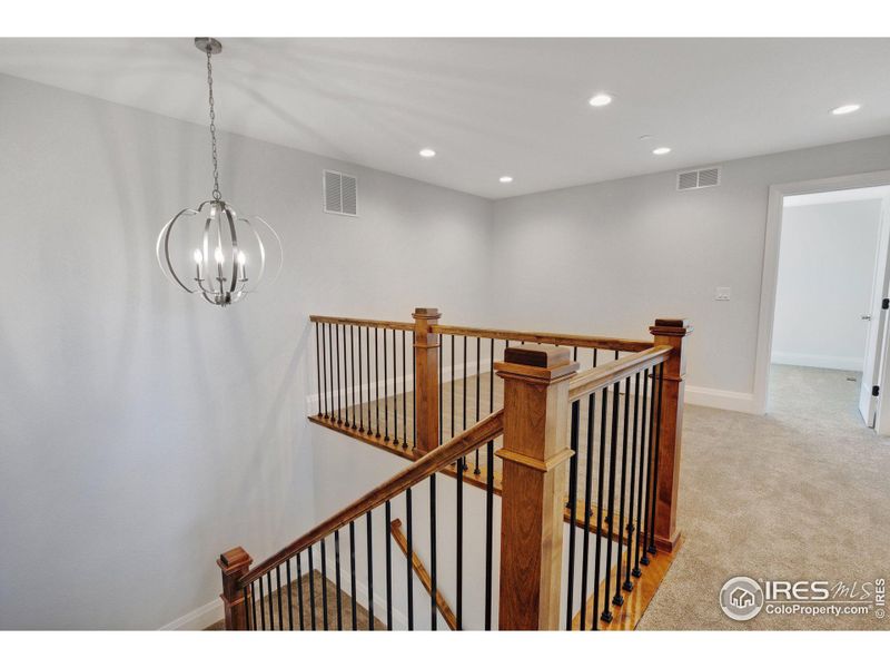 Stylish wrought-iron bannisters lead to the loft