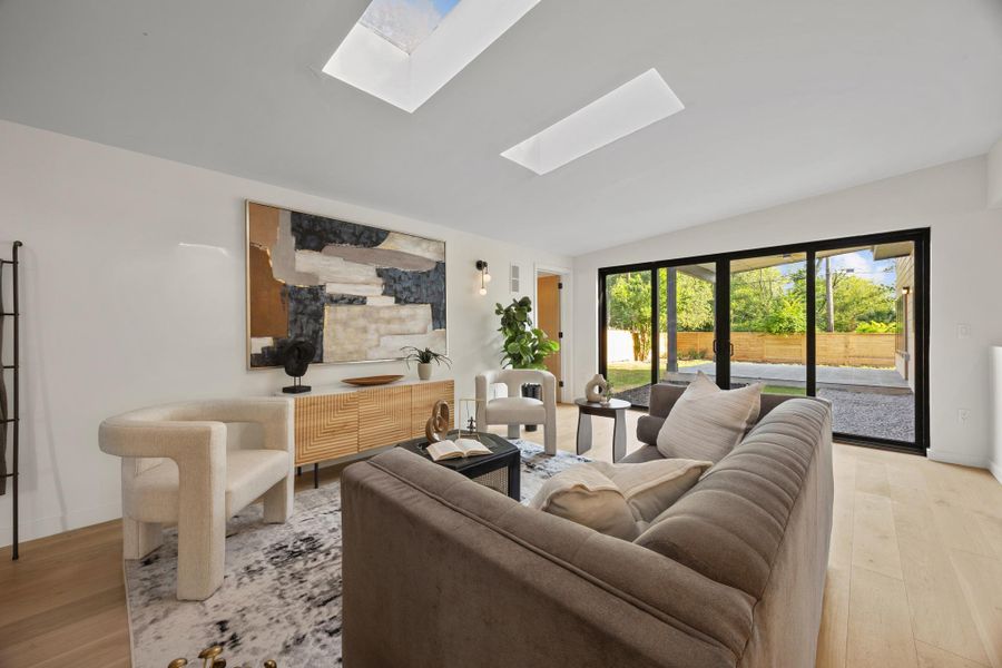 Natural light streams into this welcoming living space through dual skylights and expansive sliding glass doors Natural light streams into this welcoming living space through dual skylights and expansive sliding glass doors