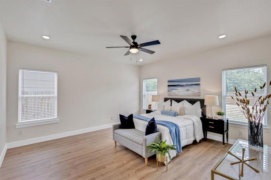 Bedroom with ceiling fan and light hardwood / wood-style floors