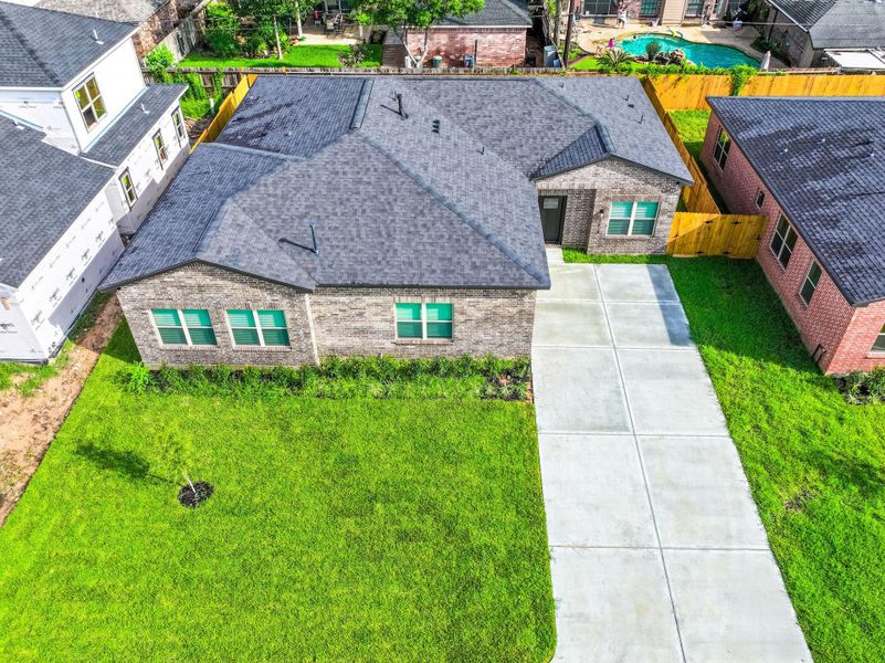 Wide driveway leads to attached garage with plenty of room