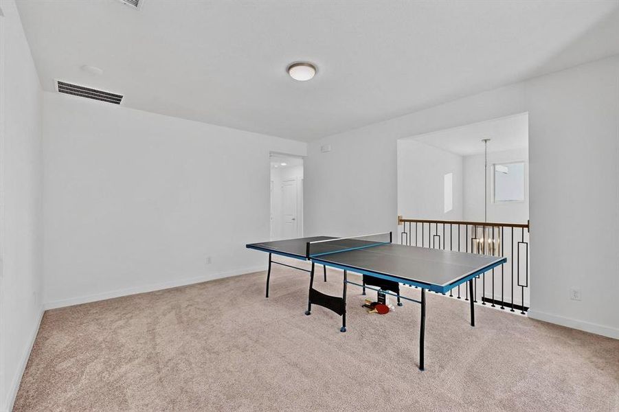 Game room featuring light carpet and baseboards Game room featuring light carpet and baseboards