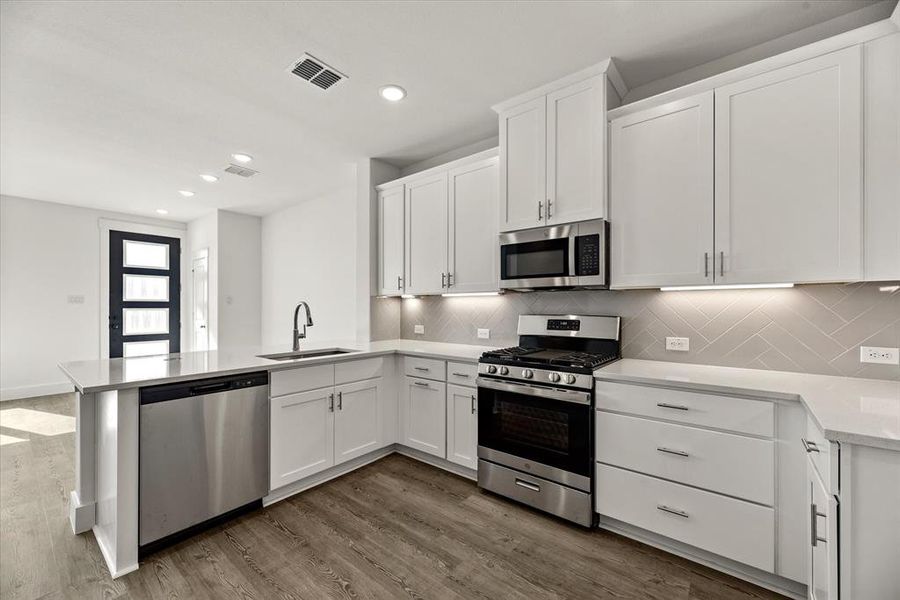 Crisp clean whites paired with modern stainless steel create the kitchen of your dreams!