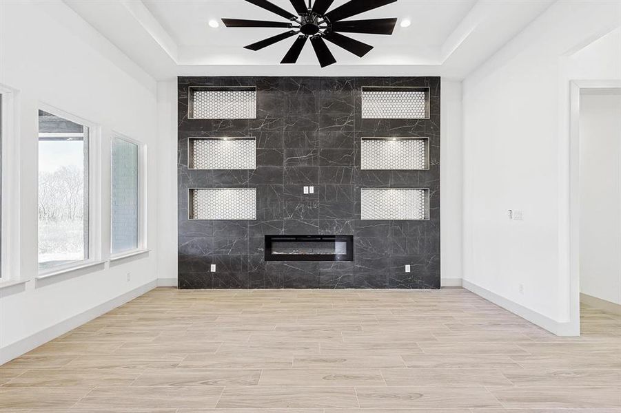 Unfurnished living room with wood tiled floors and a raised ceiling Unfurnished living room with wood tiled floors and a raised ceiling