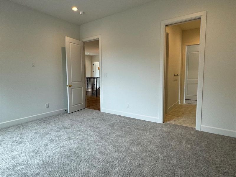 Unfurnished bedroom featuring light colored carpet