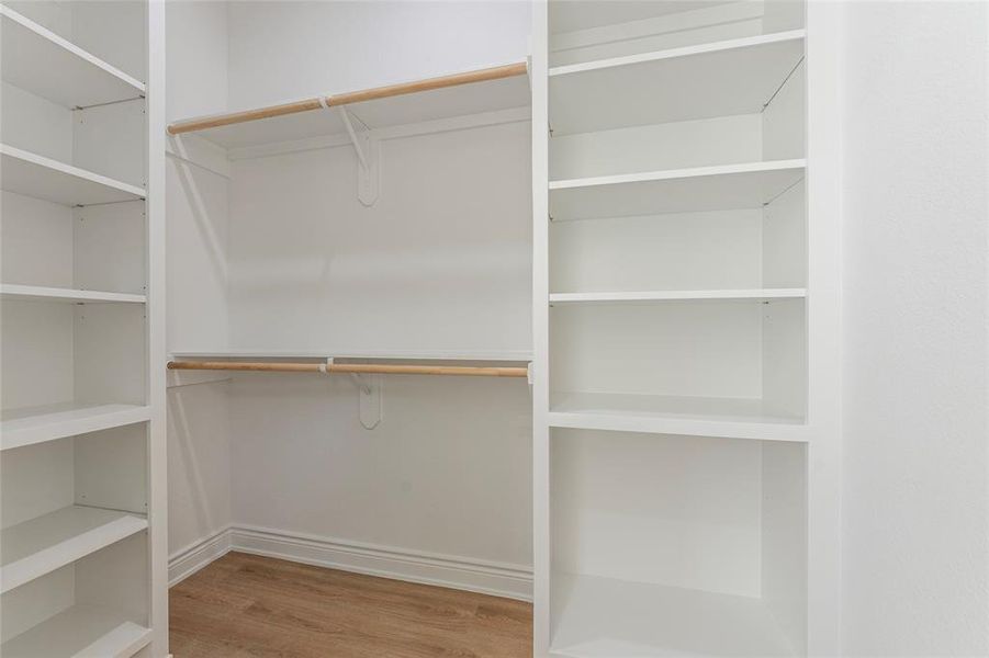 Built in shelves and hang space in the walk-in closet