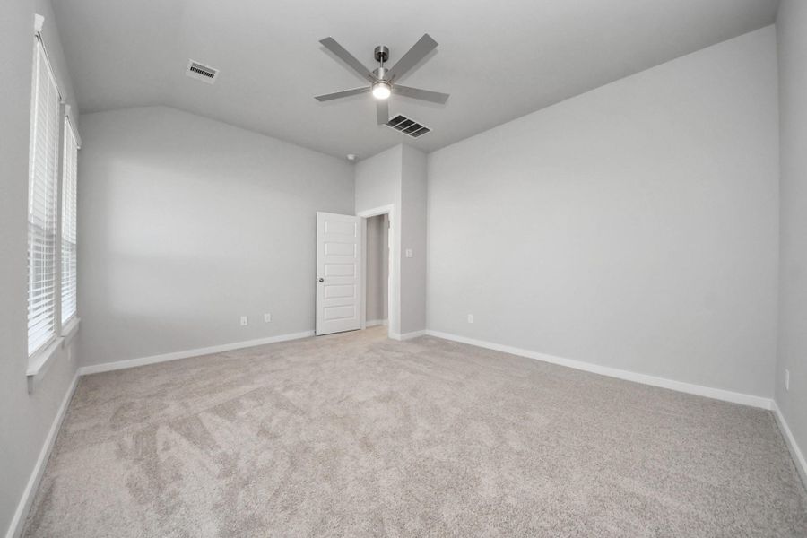 Come and unwind after a long day in this magnificent primary suite! This spacious room features plush carpet, warm paint, high ceilings and large windows with privacy blinds.