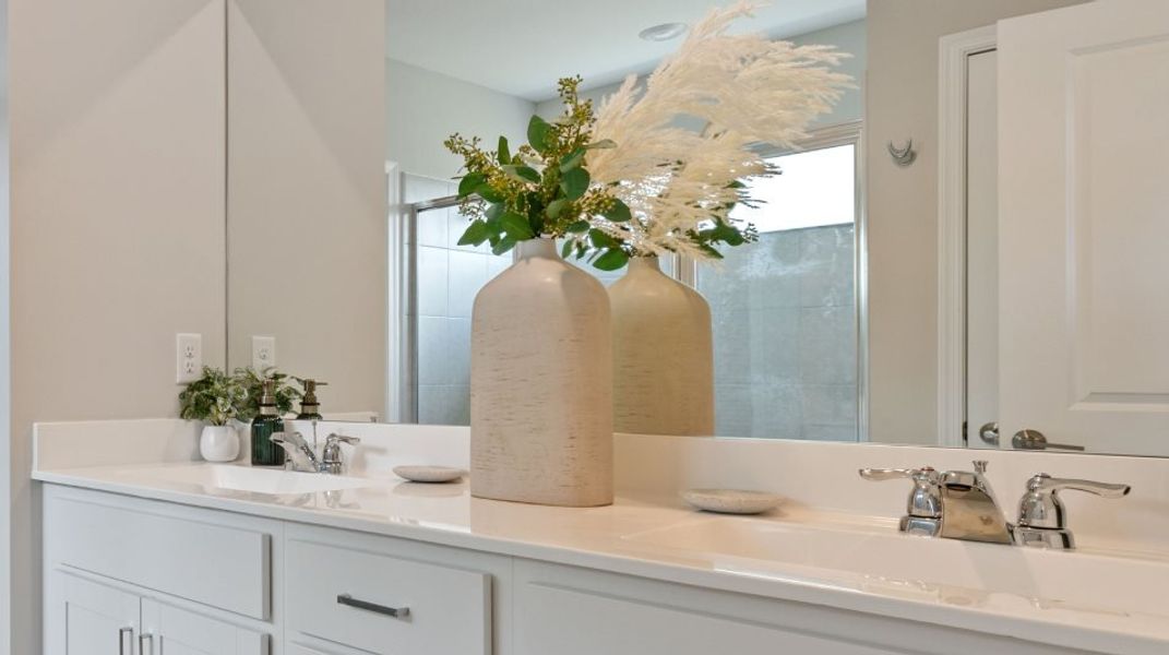 Owner's bathroom with quartz countertops