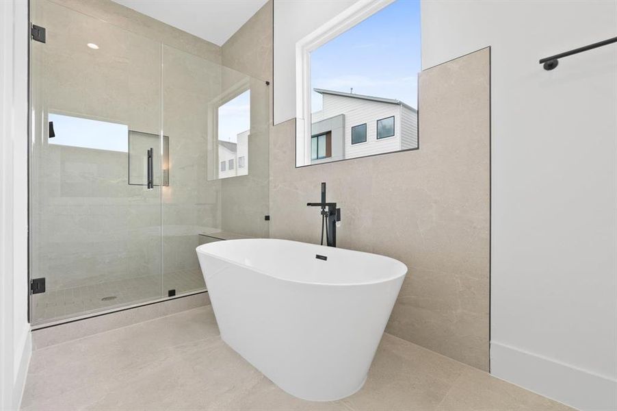 Freestanding soaking tub in the primary bathroom.