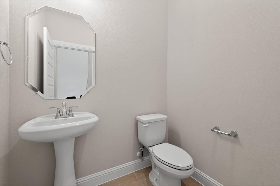 Bathroom with light tile patterned floors and baseboards