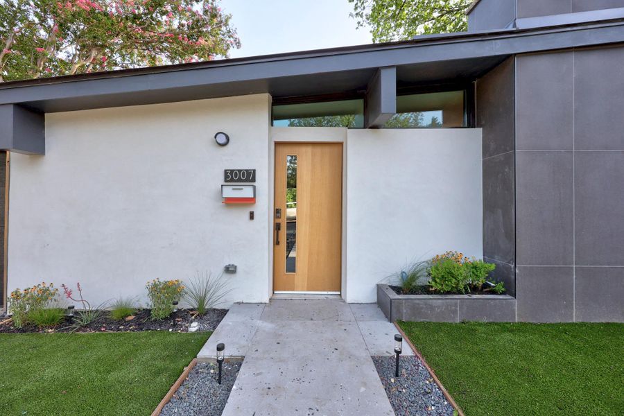 Front entrance with sleek wood door fresh and minimalist landscaping Front entrance with sleek wood door fresh and minimalist landscaping