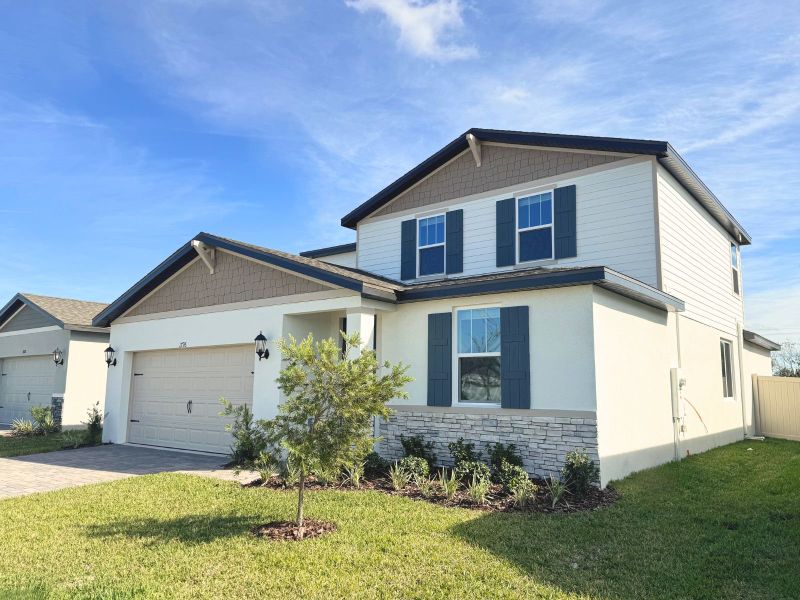 Front exterior of a new home in Two Rivers - Classic Series, Zephyrhills, FL, highlighting curb appeal (Image 2). Front exterior of a new home in Two Rivers - Classic Series, Zephyrhills, FL, highlighting curb appeal (Image 2).