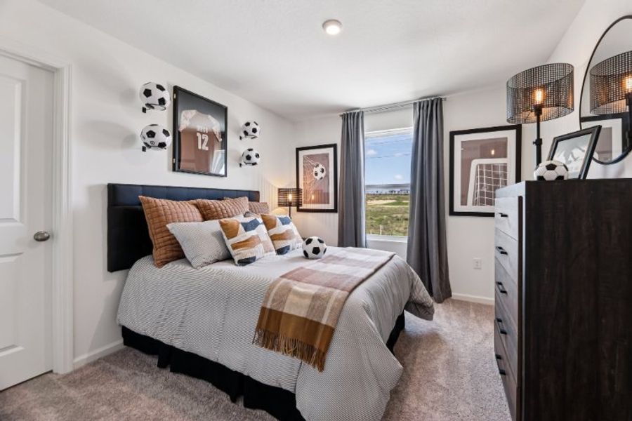 A bedroom with a large window. A bedroom with a large window.