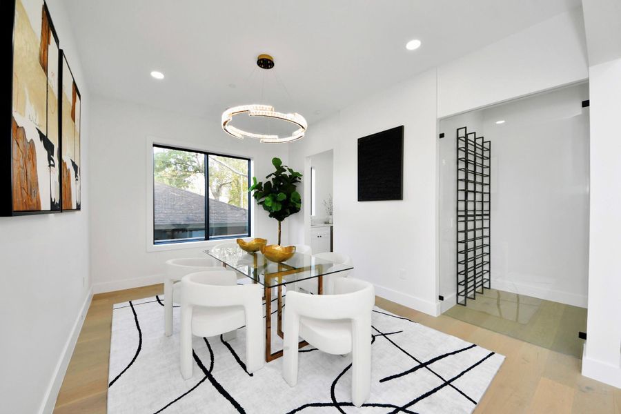 Designed for both functionality and refinement, the formal dining room connects to the wine room and kitchen through a convenient hallway, ensuring smooth transitions.