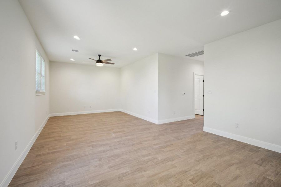 Living Area with visible vents, light wood-style floors, ceiling fan, and recessed lighting Living Area with visible vents, light wood-style floors, ceiling fan, and recessed lighting