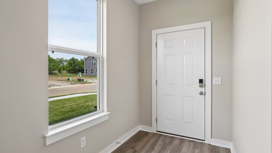 Front door to home with nearby window