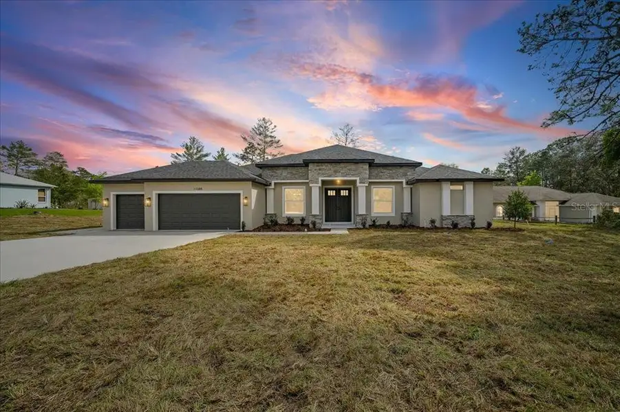 Front exterior of a new home in , Weeki Wachee, FL, highlighting curb appeal (Image 25).