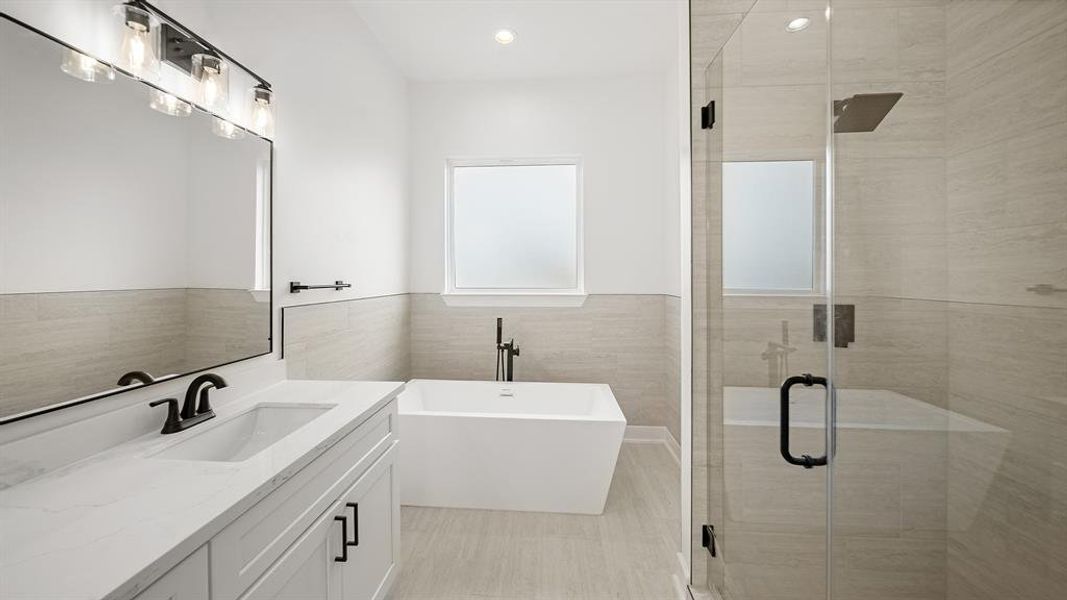 It is complete with a walk-in shower, and a stand alone tub with a privacy frozen glass.