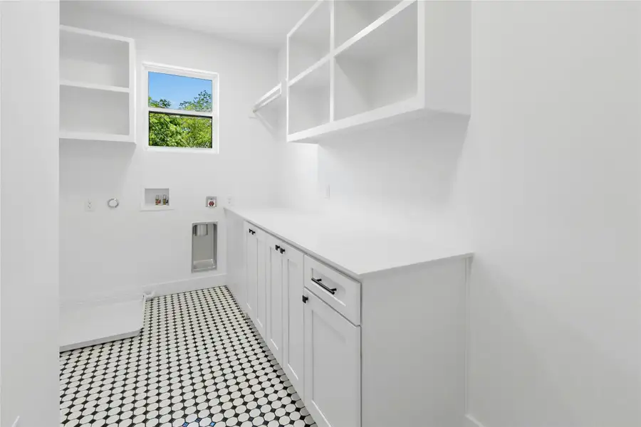 Laundry room featuring electric dryer hookup, gas dryer hookup, washer hookup, and cabinet space Laundry room featuring electric dryer hookup, gas dryer hookup, washer hookup, and cabinet space