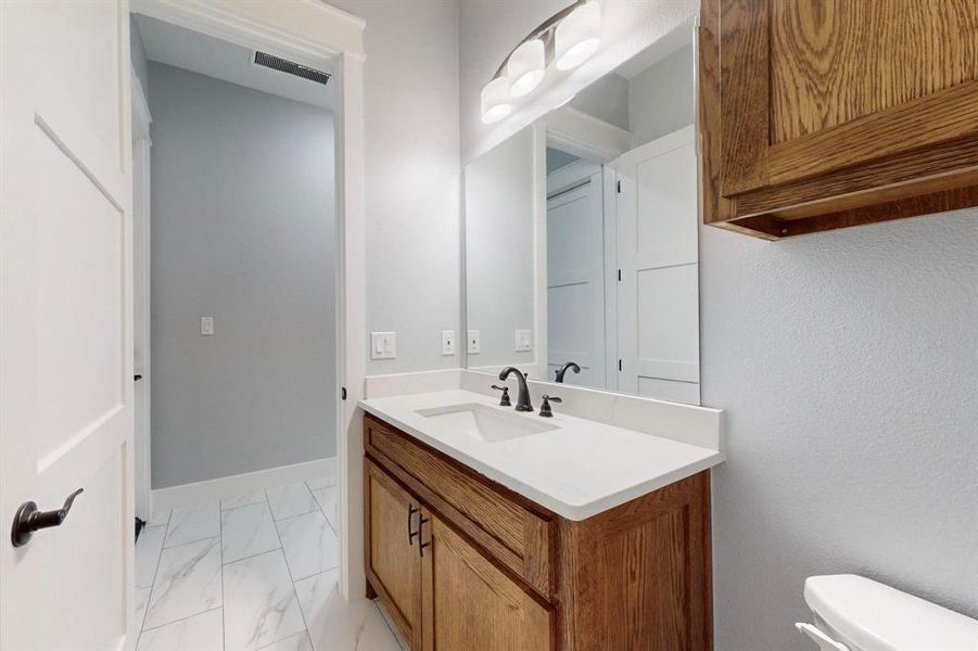 Bathroom featuring vanity and toilet